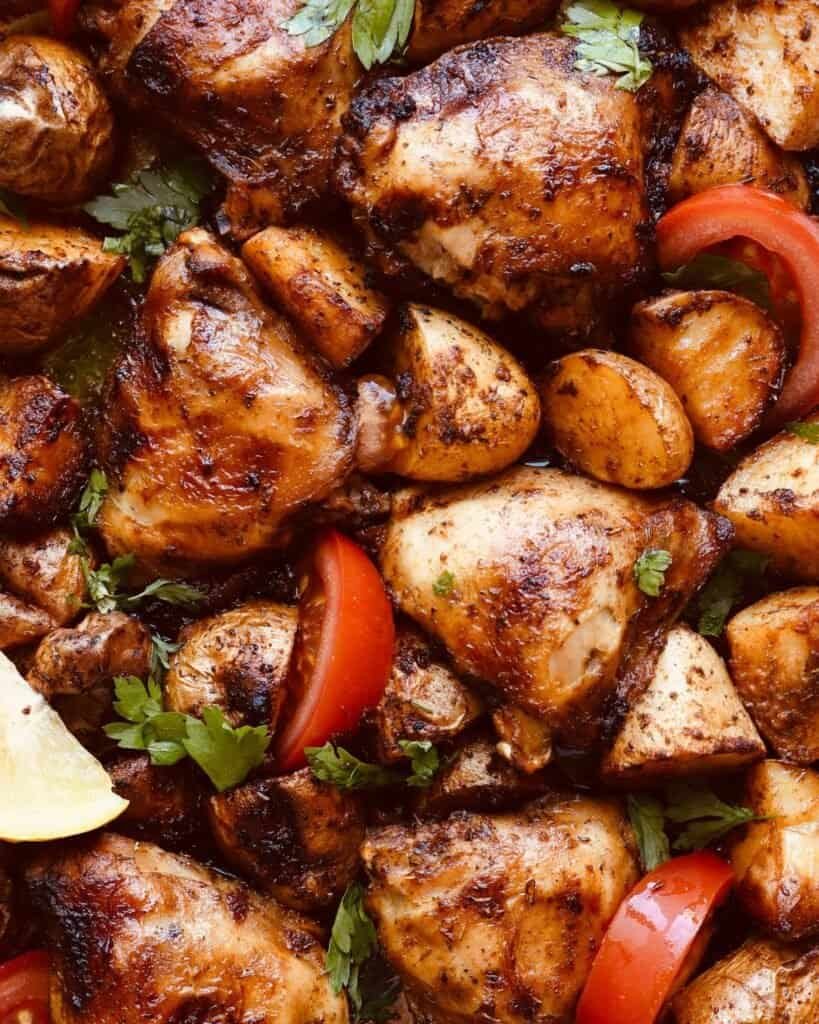 Juicy paprika chicken with roasted potatoes and fresh herbs, perfect for oven or air fryer cooking.