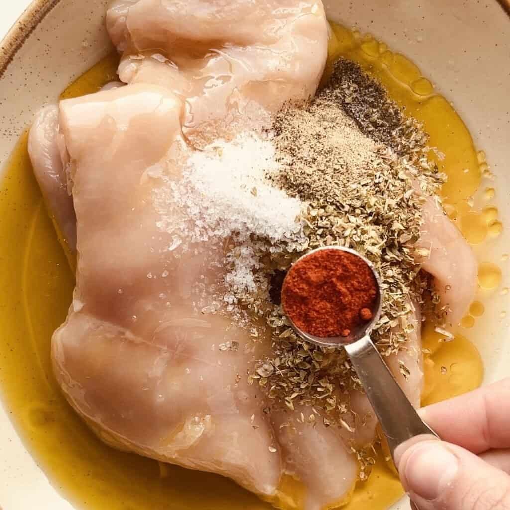 Grilled chicken with lemon garlic marinade and spices in a bowl.