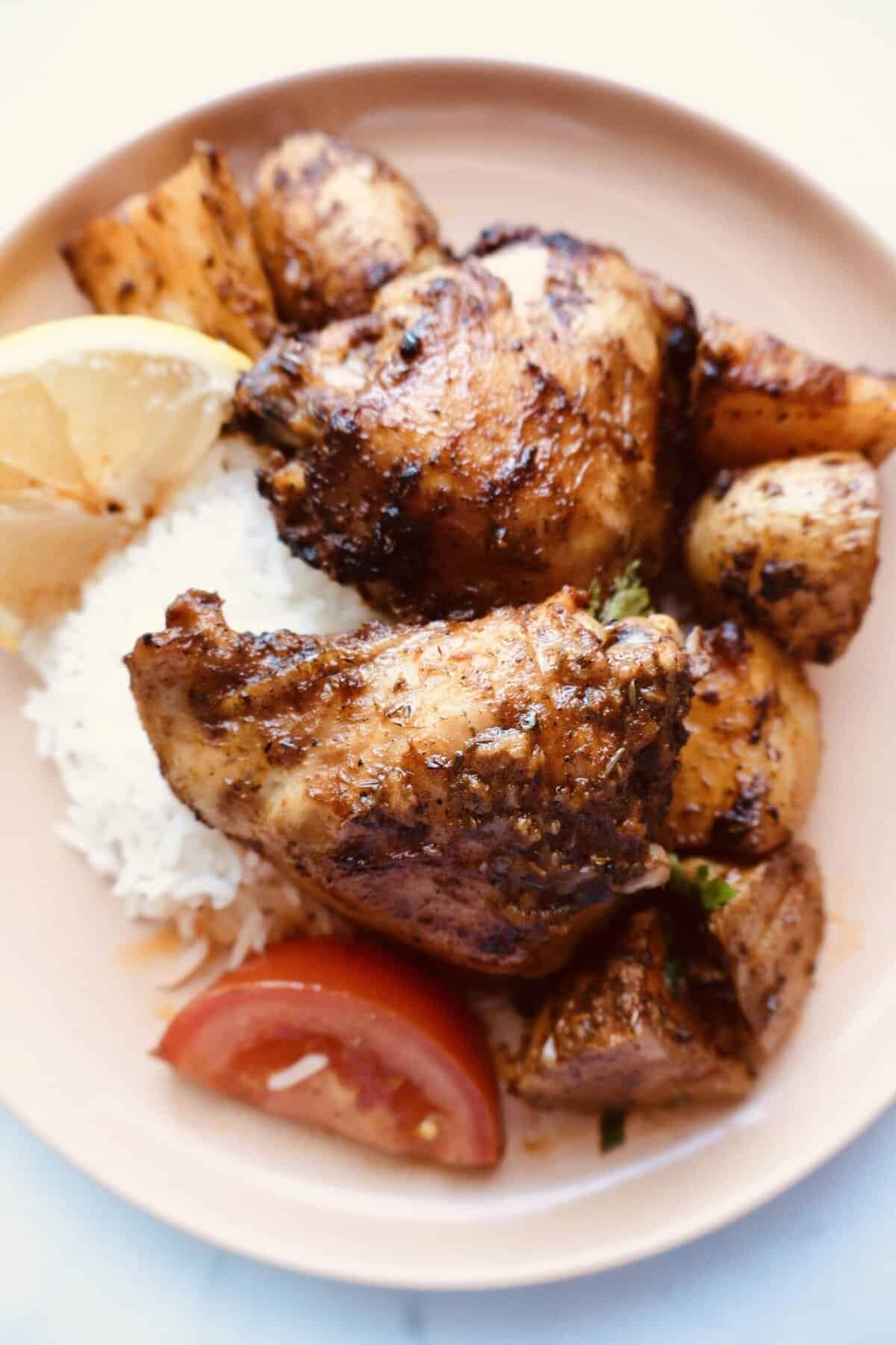 paprika chicken and potatoes on a plate with rice