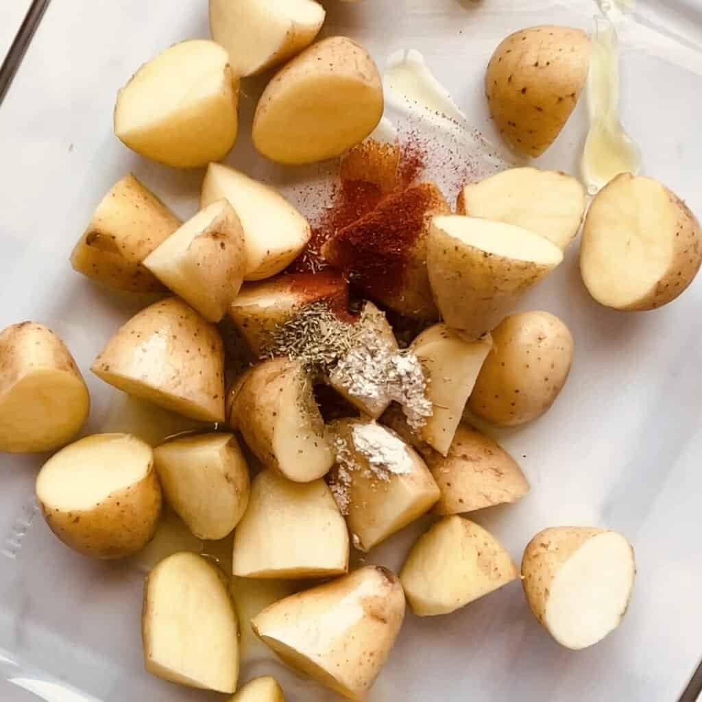 Juicy potatoes, paprika, and seasonings ready for oven or air fryer cooking.