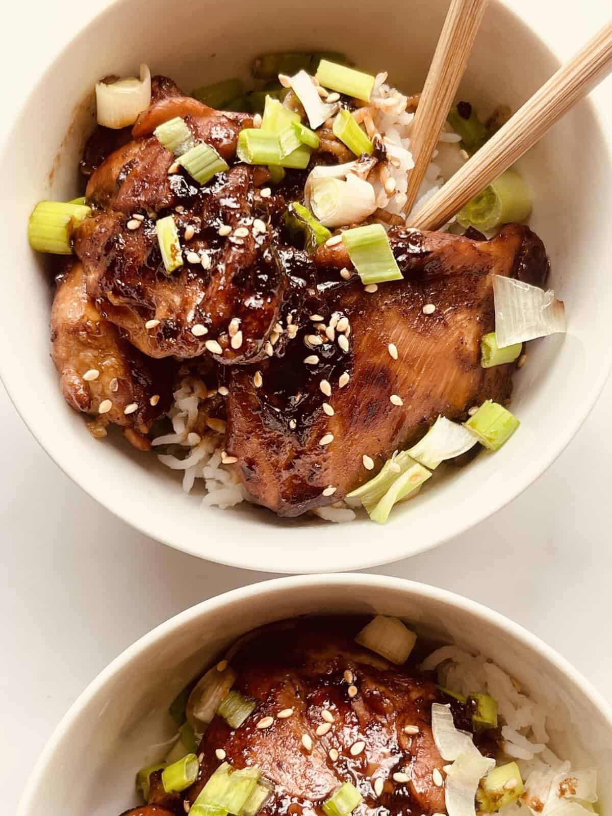 Delicious soy garlic chicken served over rice with green onions and sesame seeds.