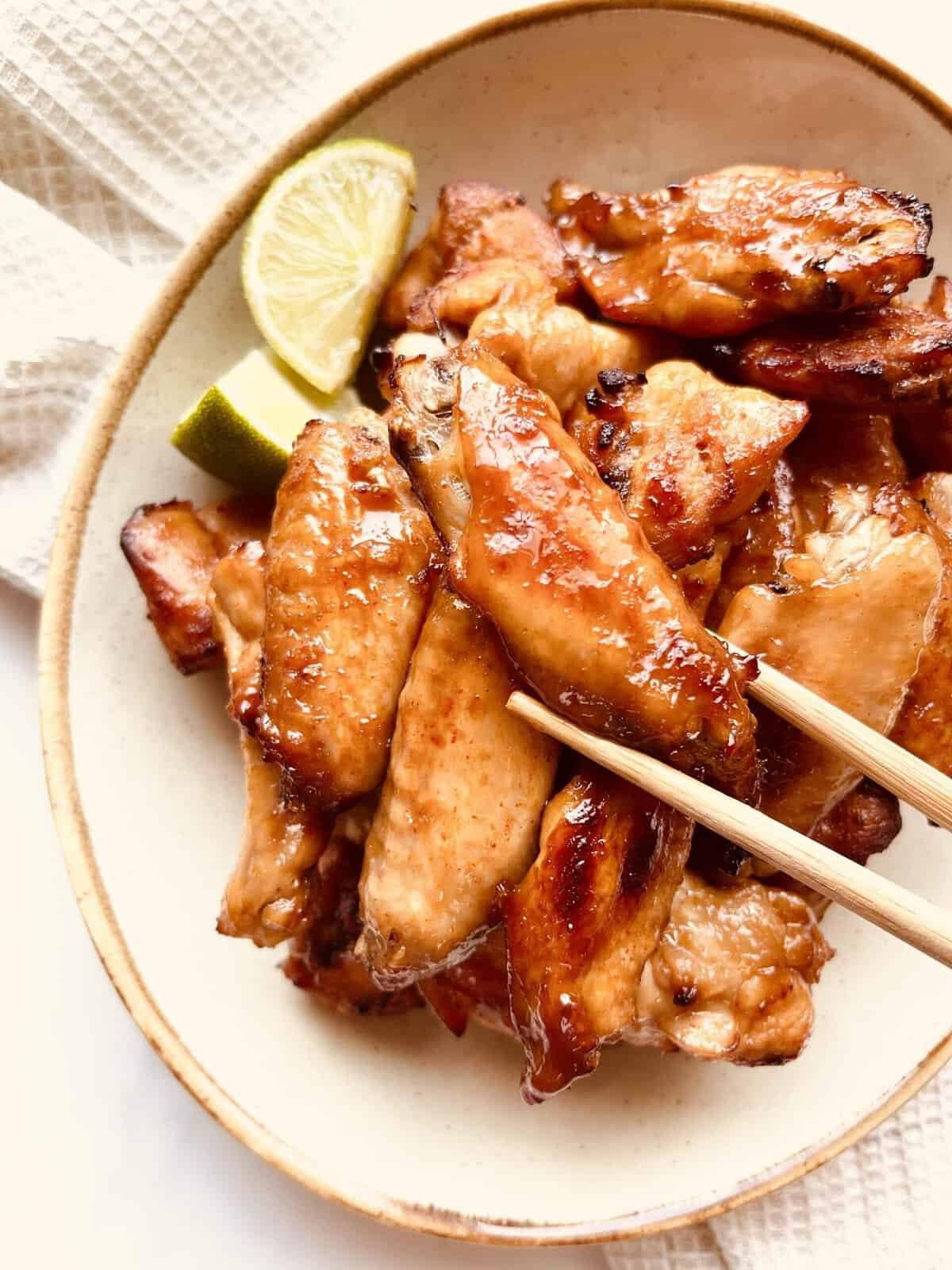 Gochujang Chicken Wings with Lime Wedges, perfect for Asian-inspired appetizers.