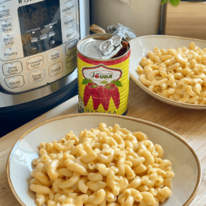 Creamy mac and cheese with harissa in an Instant Pot, served in white bowls for a quick and flavorful meal.
