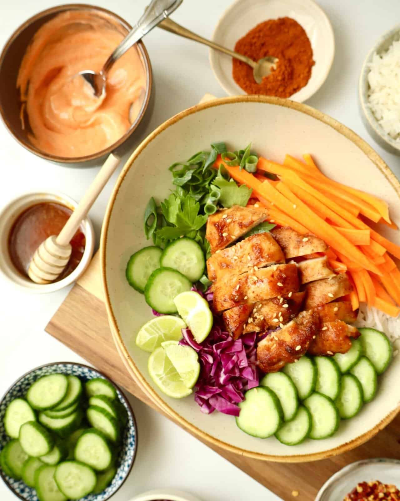 Grilled chili honey chicken with fresh vegetables and rice bowl, perfect for a flavorful meal.