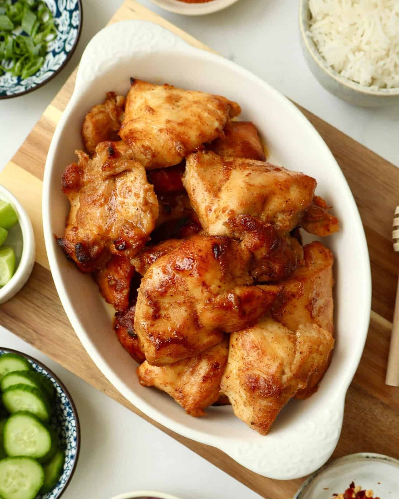 Crispy chili honey chicken served with rice in a white dish.