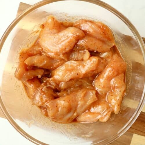 Juicy chicken pieces marinated in chili honey sauce for flavorful grilling or cooking.