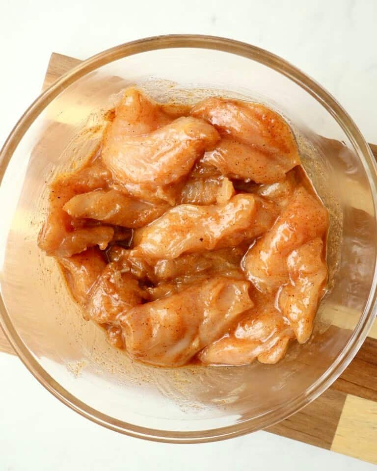 Juicy chicken pieces marinated in chili honey sauce for flavorful grilling or cooking.