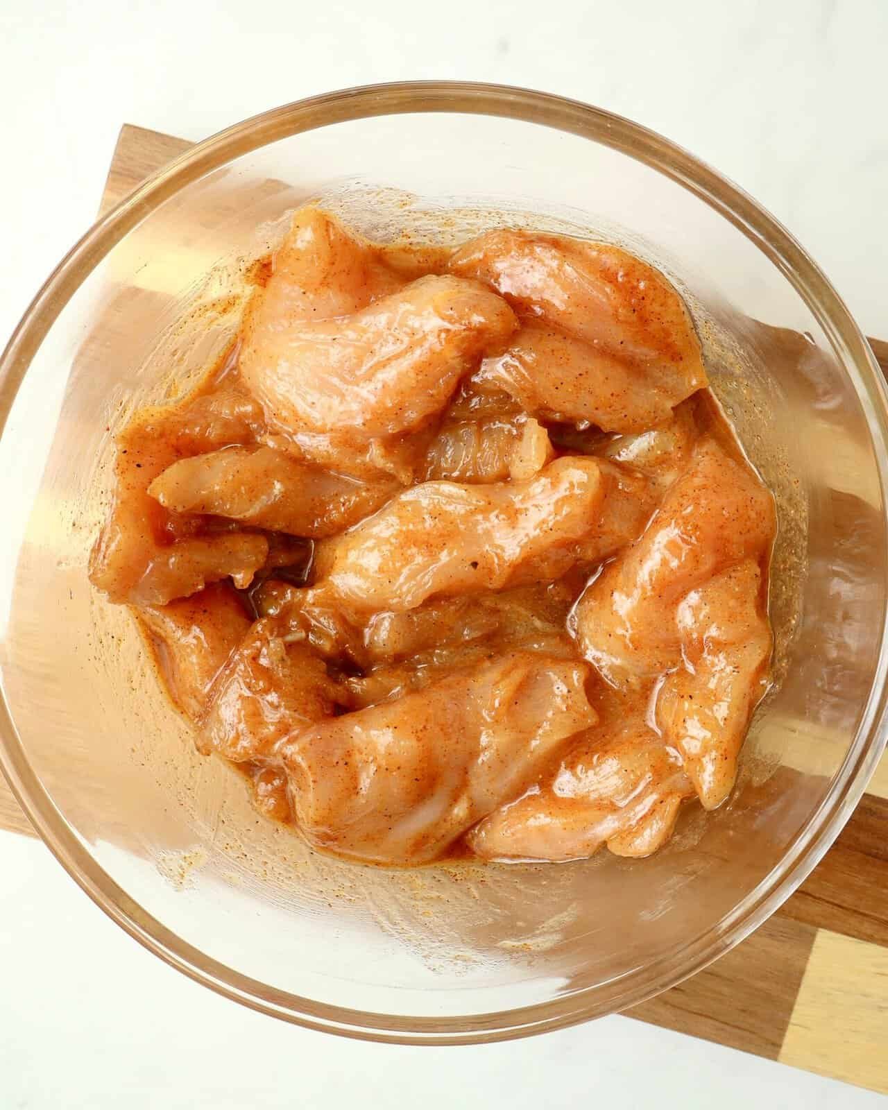 Juicy chicken pieces marinated in chili honey sauce for flavorful grilling or cooking.
