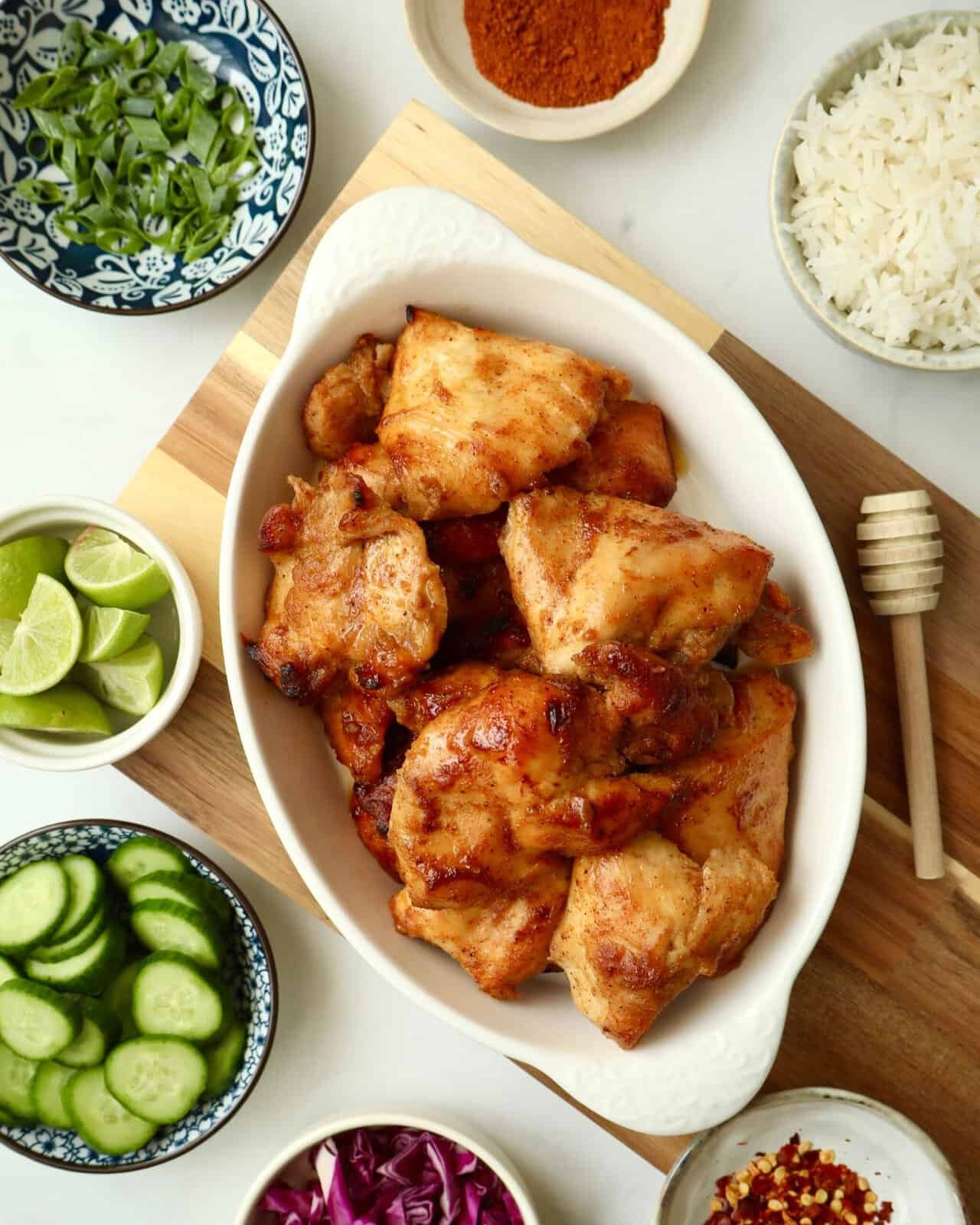 Juicy chili honey chicken marinade with fresh lime, cucumber, and rice for a flavorful meal.