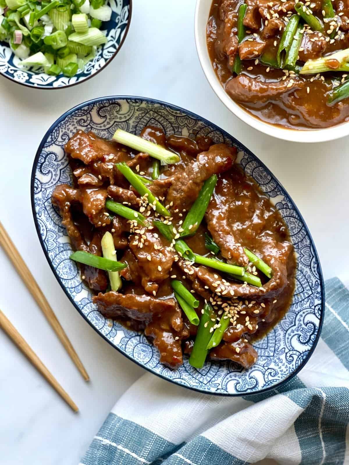 Sweet and savory beef stir-fry with green onions and sesame seeds, perfect for a quick Asian-inspire.