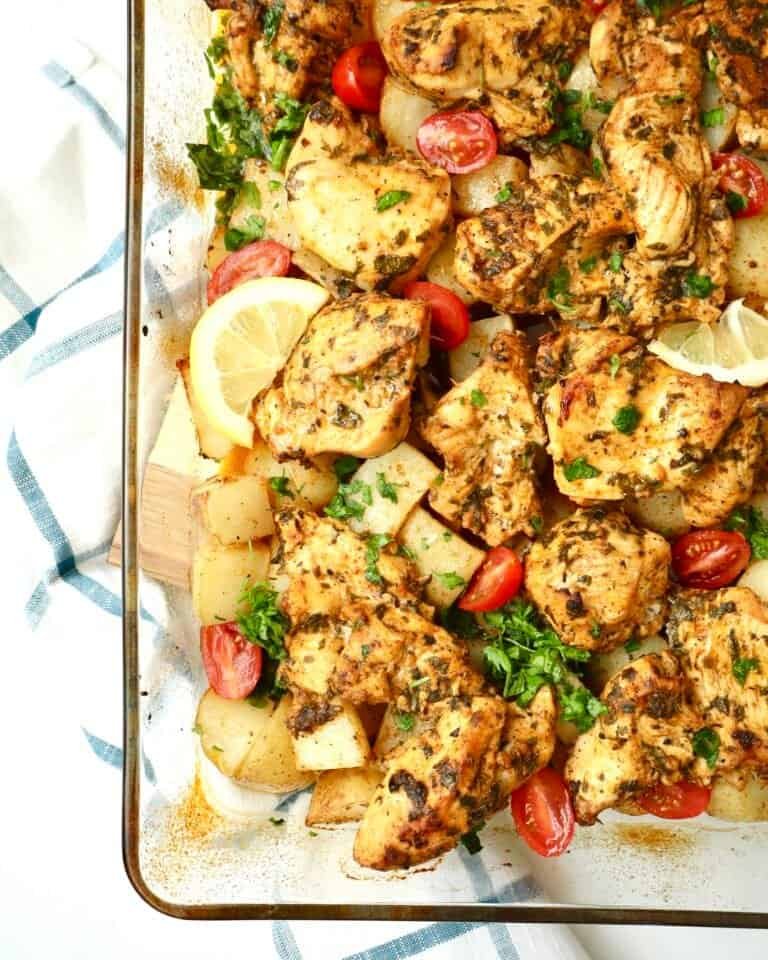 Golden, juicy Dump and Bake Mediterranean Chicken and Potatoes baked in one pan with garlic, lemon, and herbs for an easy weeknight dinner.