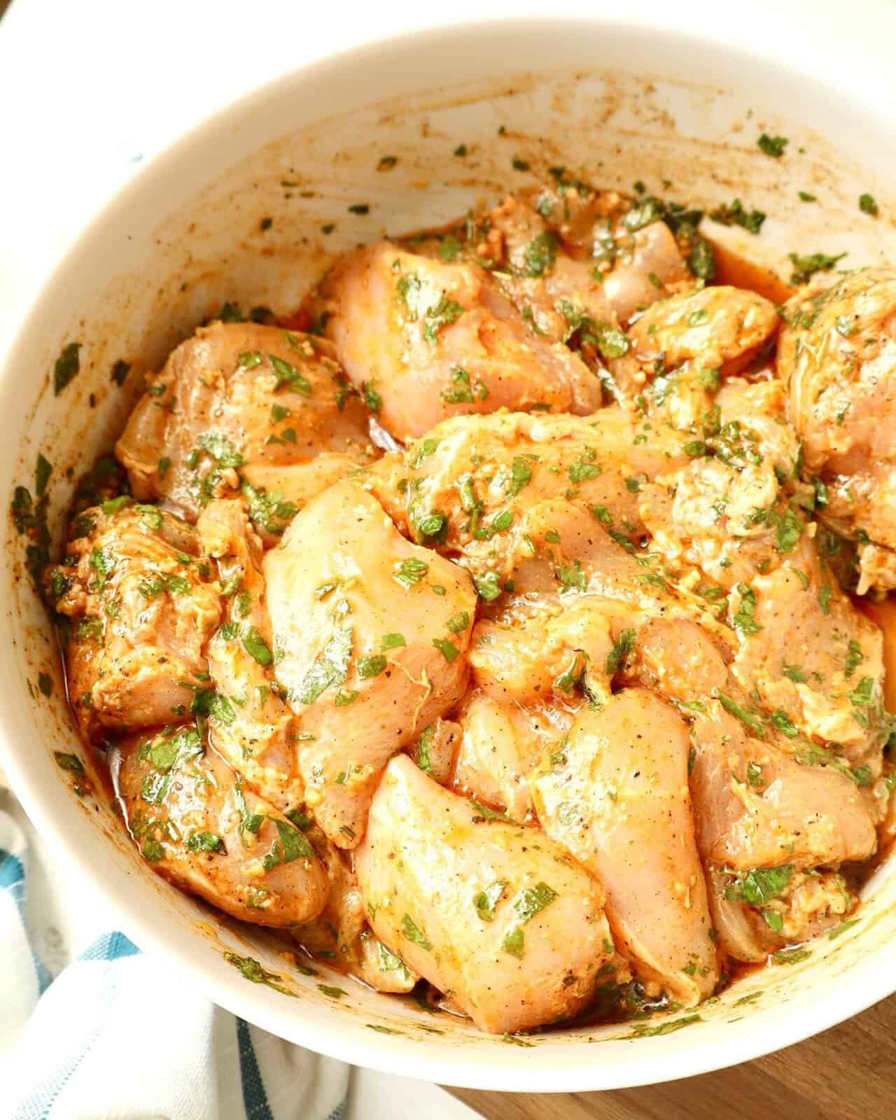 Close-up of Mediterranean Herb Chicken Marinade mixed in white glass bowl