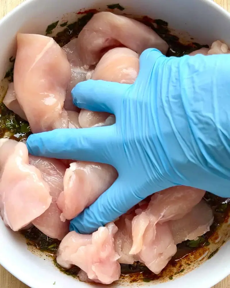 Mixing by hand the Mediterranean Herb Chicken Marinade Ingredients in a bowl