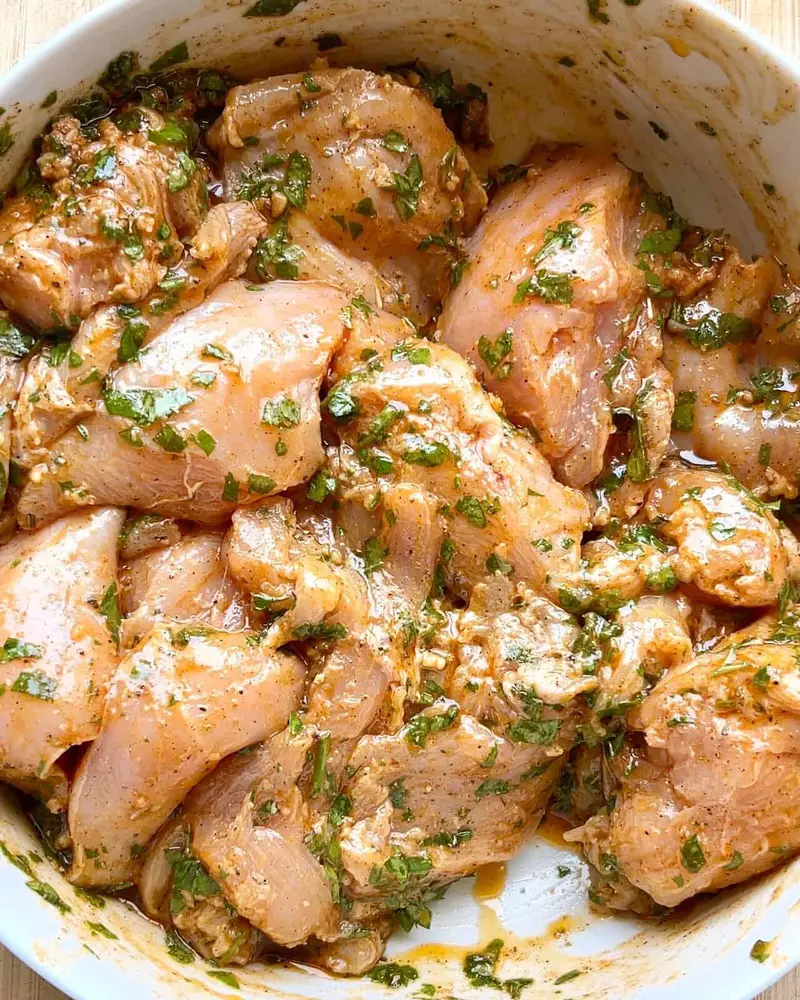 Homemade Mediterranean Herb Chicken Marinade with garlic and spices in bowl