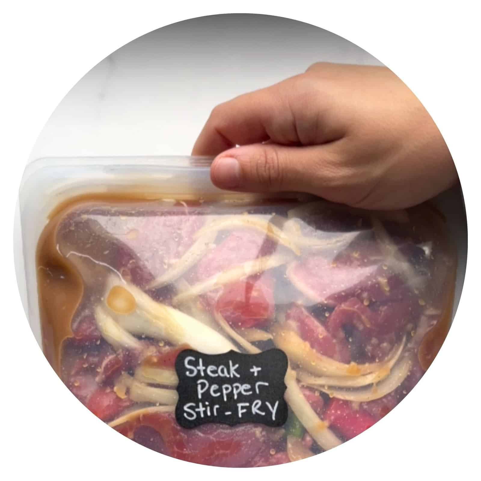 Steak and pepper stir-fry in a sealed bag, ready for cooking or marinating. Perfect for quick, flavo.