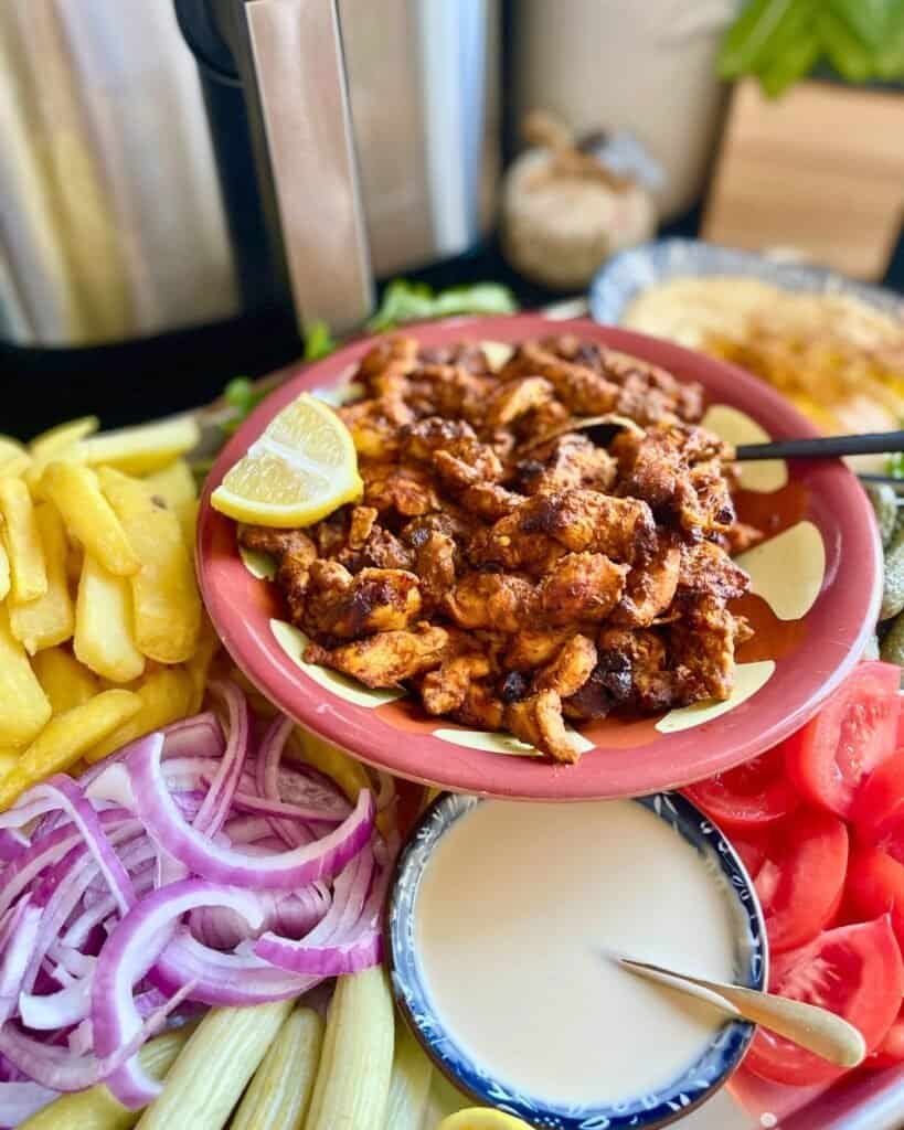 Juicy air fryer chicken shawarma served with fresh vegetables and creamy sauce. Perfect for quick we.