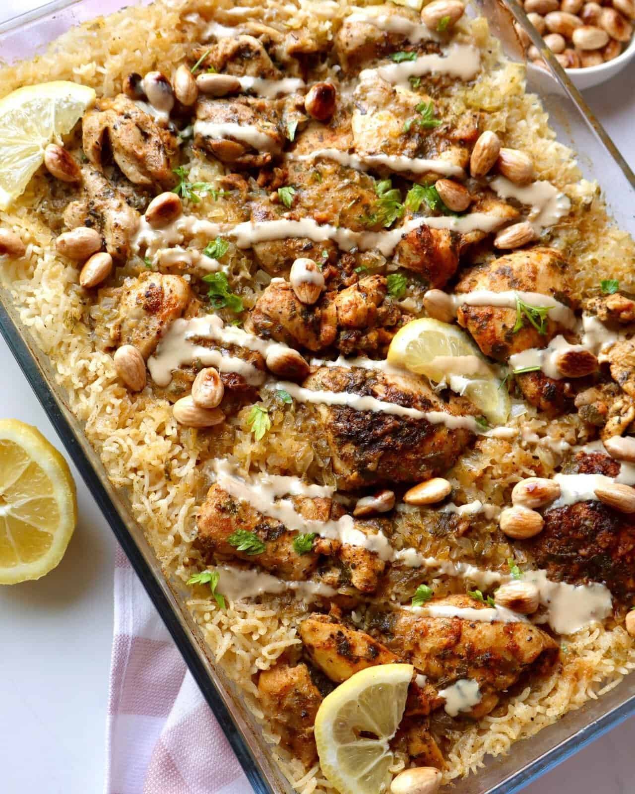 Mediterranean chicken and rice bake with lemon, herbs, and toasted pine nuts in a one-pan dinner dis.