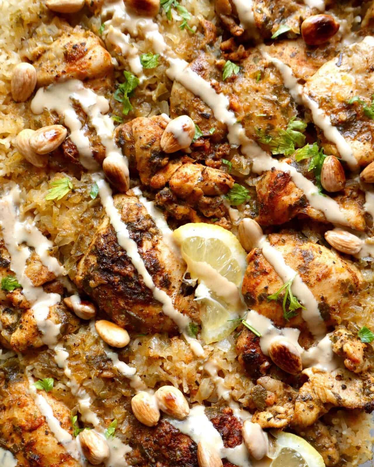 Juicy Mediterranean chicken and rice bake with herbs, nuts, and creamy sauce, perfect for easy one-pan.