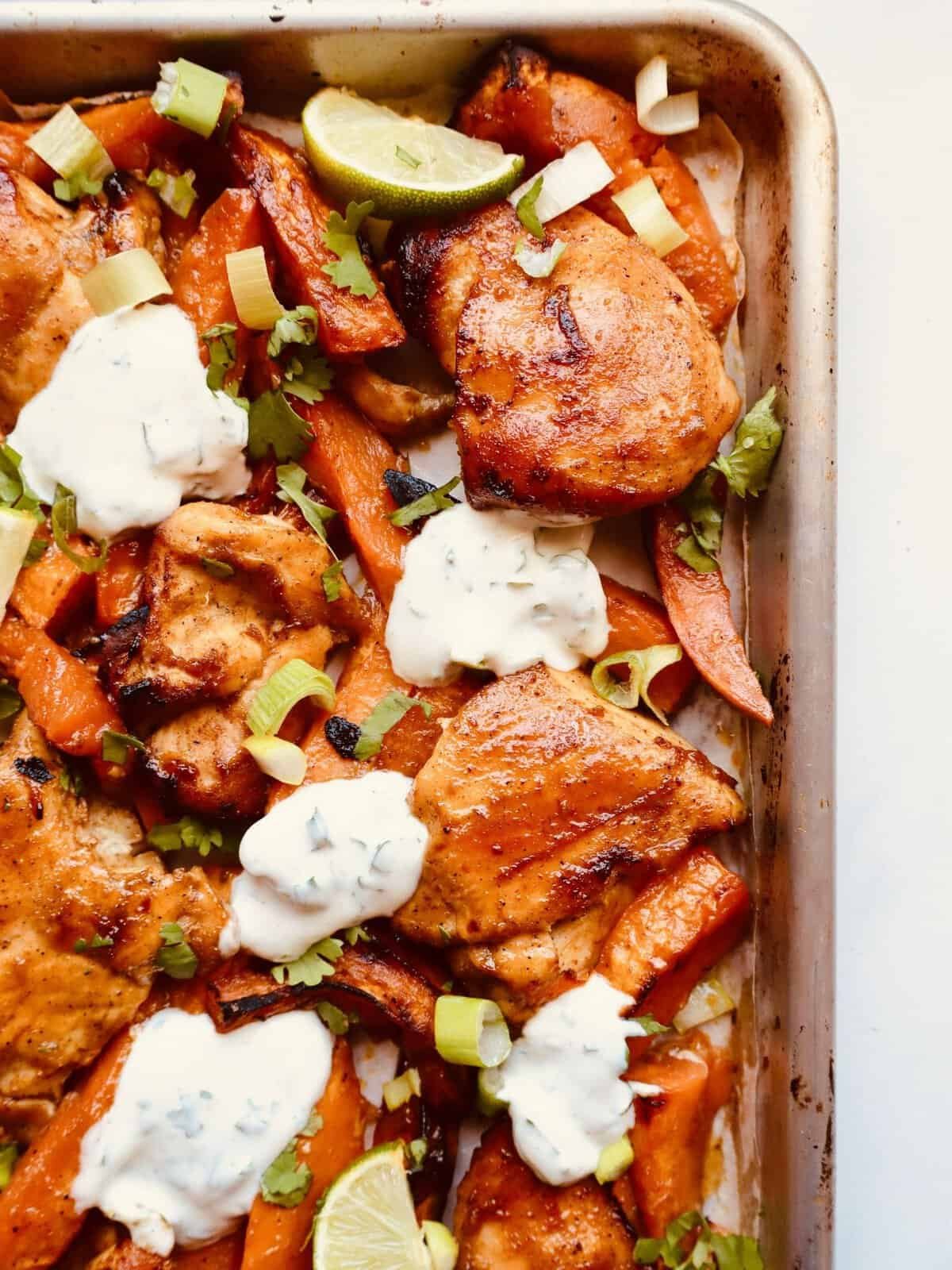 Sheet pan chili honey chicken with sweet potatoes and cilantro yogurt sauce, easy weeknight dinner recipe.