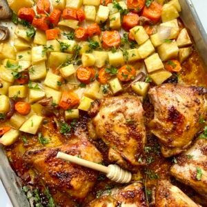 Juicy honey Dijon chicken thighs with roasted vegetables on a sheet pan. Perfect easy dinner recipe.