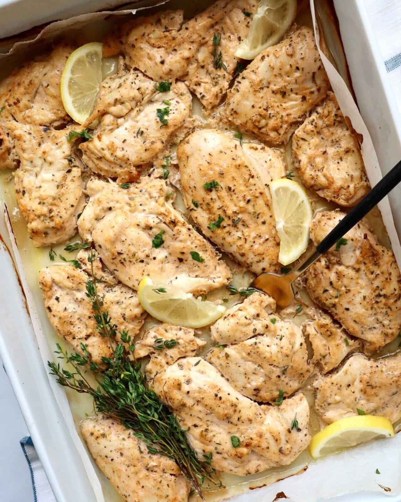 Succulent baked chicken thighs with lemon and herbs, perfect for a flavorful, easy dinner.