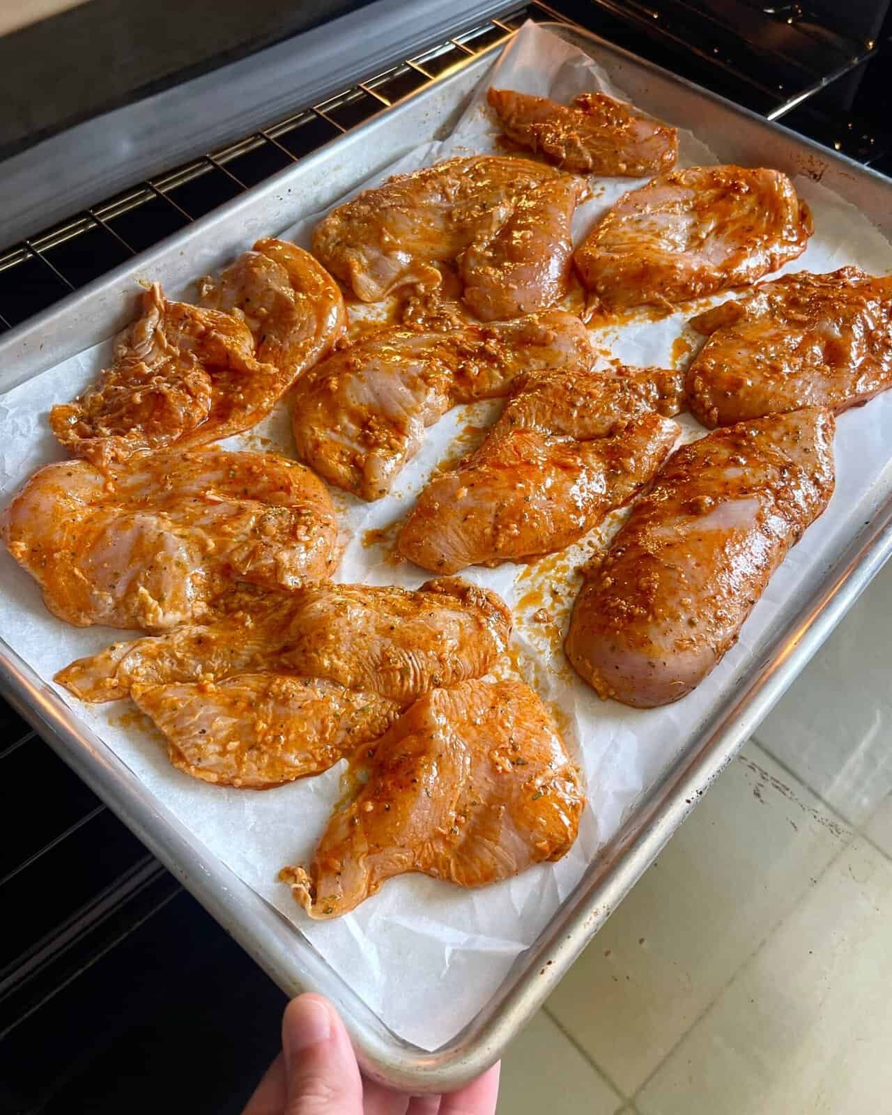 chicken breasts spaced evenly on a baking tray for even cooking