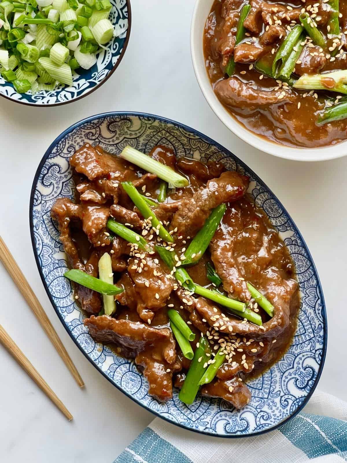 Easy Instant Pot Mongolian beef takeout style dinner with sticky sauce and sesame seed topping