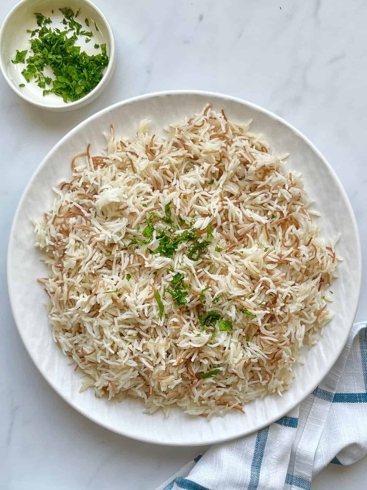 Light and fluffy Lebanese rice pilaf with golden vermicelli noodles and chopped parsley, perfect for pairing with chicken or grilled dishes