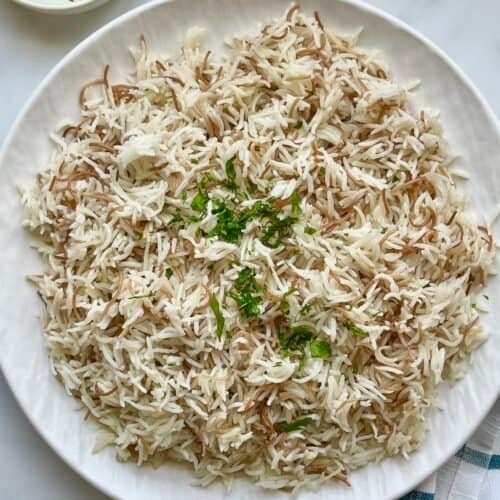 Fluffy Lebanese rice with vermicelli served warm and garnished with fresh parsley, a simple and authentic Middle Eastern side dish