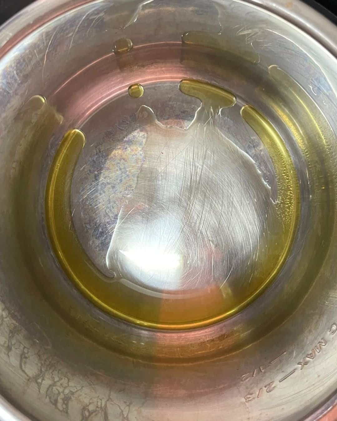 Olive oil heating in Instant Pot on sauté mode before adding beef for searing