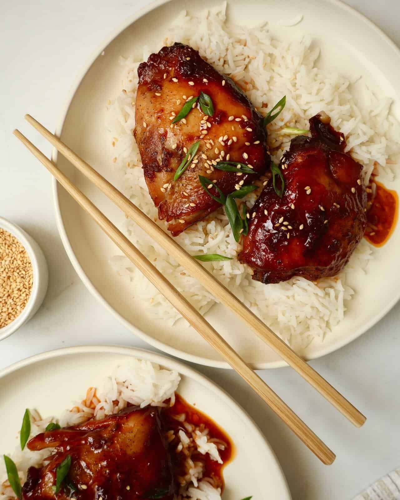 Sticky garlic chicken served over fluffy jasmine rice with sesame seeds.