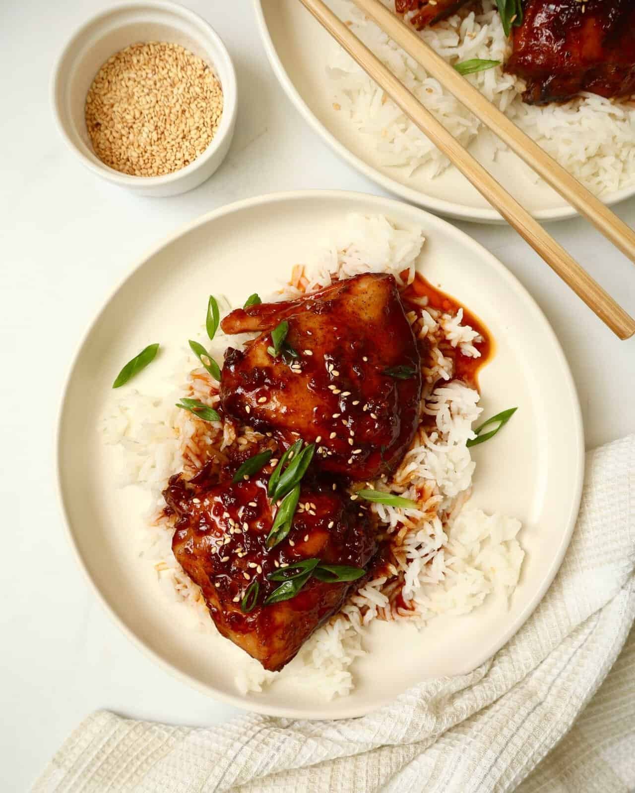 Slow cooker chicken thighs coated in glossy garlic honey sauce.