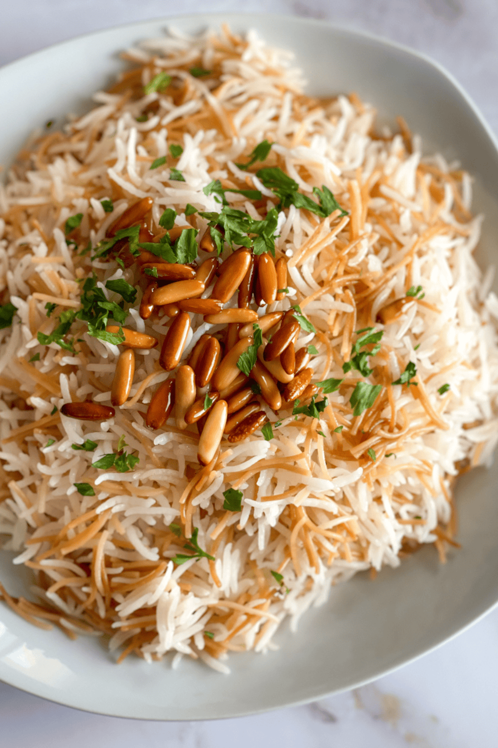 Close-up of Lebanese rice pilaf with golden vermicelli, toasted pine nuts, and fresh parsley, fluffy and perfectly cooked