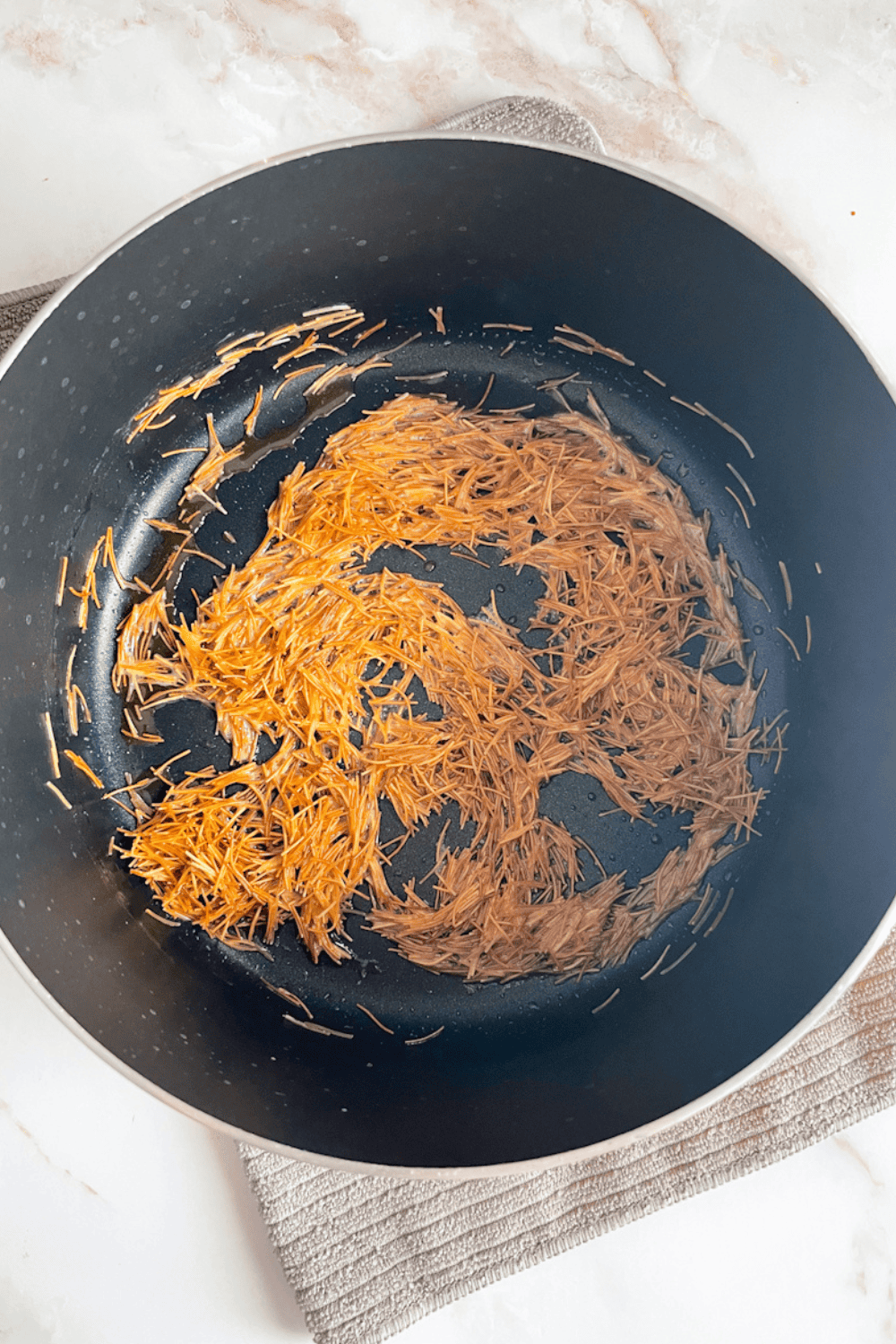 Vermicelli toasted to deep golden brown in a pot, the key step for authentic Lebanese rice flavor